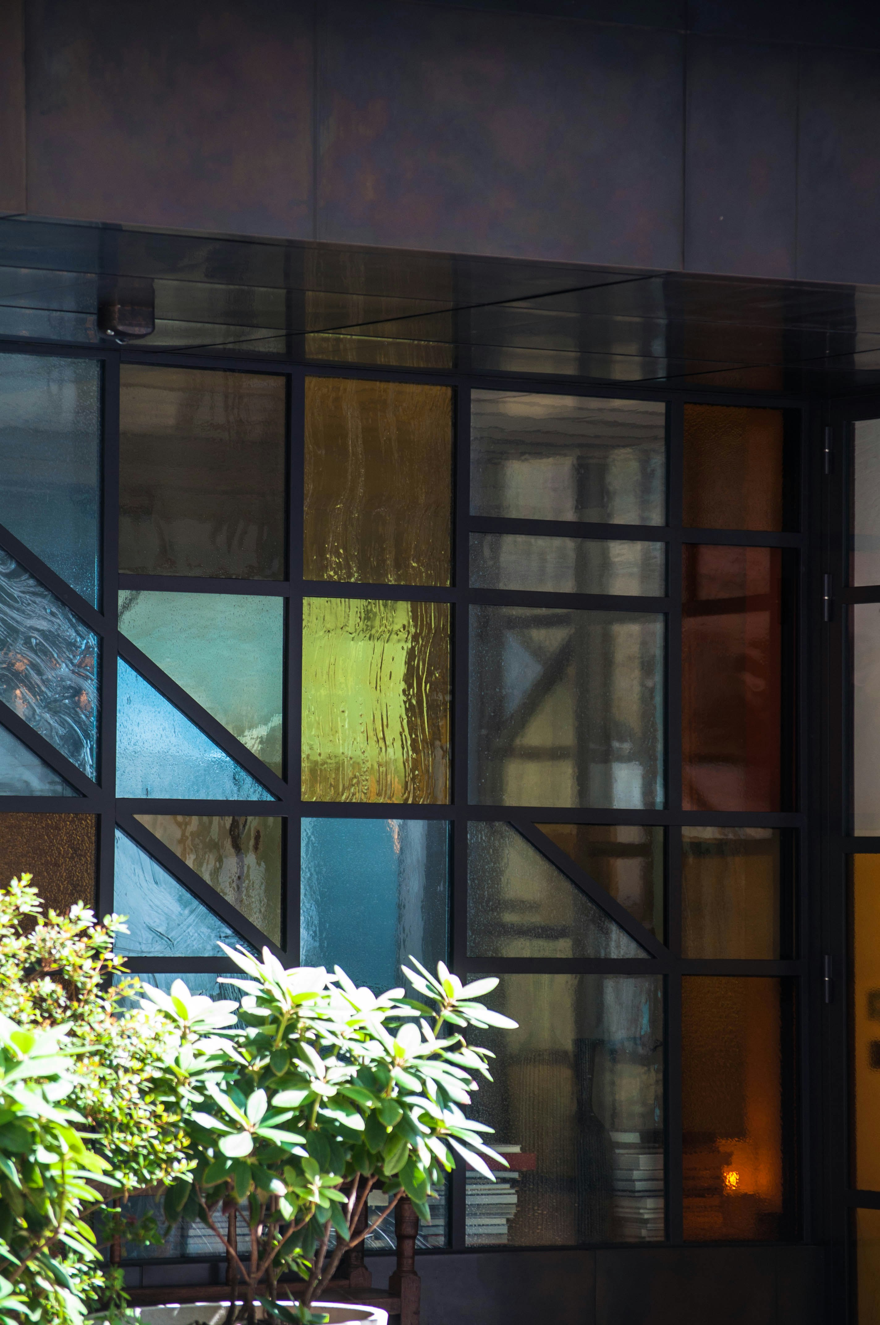 white flowers in front of brown wooden framed glass window